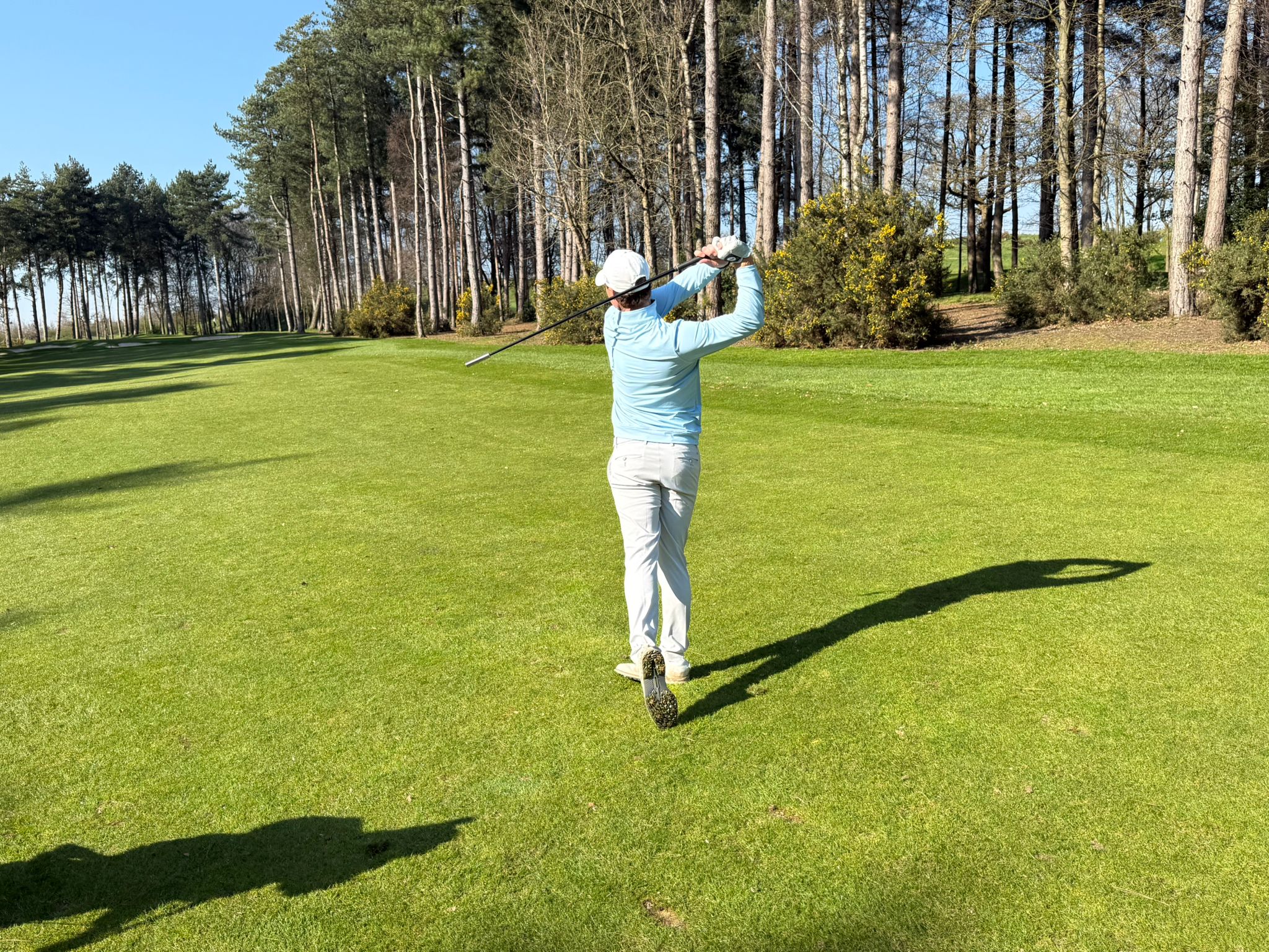 Founder swinging on the fairway
